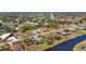 Aerial view of a residential neighborhood showing a single-Gathering home near a canal at 411 Boundary Blvd, Rotonda West, FL 33947