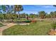 Landscaped backyard with fire pit and seating area at 411 Boundary Blvd, Rotonda West, FL 33947