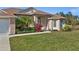 Front entryway with double doors, columns, and vibrant landscaping at 411 Boundary Blvd, Rotonda West, FL 33947