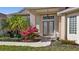 Inviting front entry with double doors and flowering bougainvillea at 411 Boundary Blvd, Rotonda West, FL 33947