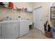 Laundry room with washer, dryer, and storage at 411 Boundary Blvd, Rotonda West, FL 33947