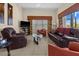 Comfortable living room featuring leather sofas and a flat-screen TV at 411 Boundary Blvd, Rotonda West, FL 33947