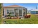 Screened enclosure with various potted plants at 411 Boundary Blvd, Rotonda West, FL 33947