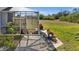 Screened patio area with potted plants and tools at 411 Boundary Blvd, Rotonda West, FL 33947