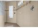 Spacious shower with glass block windows and neutral tile at 411 Boundary Blvd, Rotonda West, FL 33947