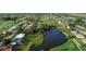 Scenic aerial view of homes on the water connected to a golf course at 429 Rotonda Cir, Rotonda West, FL 33947