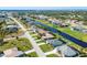 Aerial view of a community with waterfront homes along a canal and neighborhood street at 429 Rotonda Cir, Rotonda West, FL 33947