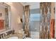 Well-maintained bathroom features granite counters, a modern shower, and a patterned shower curtain at 429 Rotonda Cir, Rotonda West, FL 33947