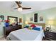 Well-lit bedroom with stylish decor, ceiling fan, and matching nightstands and dresser at 429 Rotonda Cir, Rotonda West, FL 33947