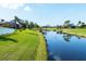 Scenic canal view from the property, surrounded by green lawns and lush landscaping at 429 Rotonda Cir, Rotonda West, FL 33947