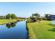 Tranquil canal view with lush green banks and a clear blue sky, creating a serene environment at 429 Rotonda Cir, Rotonda West, FL 33947