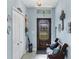 Inviting entryway featuring blue walls, decorative accents, and natural light streaming through the front door at 429 Rotonda Cir, Rotonda West, FL 33947