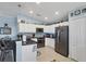 Well-lit kitchen with white cabinetry, stainless steel appliances, and modern countertop at 429 Rotonda Cir, Rotonda West, FL 33947