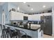 Modern kitchen with sleek black countertops, white cabinetry, and bar-style seating at 429 Rotonda Cir, Rotonda West, FL 33947