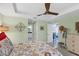 Bright main bedroom with a ceiling fan, bedside table, and connected bathroom at 429 Rotonda Cir, Rotonda West, FL 33947