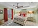 Comfortable main bedroom featuring floral bedding, modern lighting, and a fan at 429 Rotonda Cir, Rotonda West, FL 33947