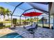 Enjoy the screened-in lanai with pool, lounge chairs, and outdoor dining overlooking the water at 429 Rotonda Cir, Rotonda West, FL 33947