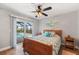 Guest bedroom with queen-size bed and pool view at 497 Rotonda Cir, Rotonda West, FL 33947