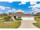 Beautiful home with two-car garage and landscaped front yard at 497 Rotonda Cir, Rotonda West, FL 33947