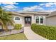 Inviting home exterior with double doors and landscaped walkway at 497 Rotonda Cir, Rotonda West, FL 33947