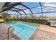 Inviting pool area with screened enclosure, grill, and ample patio space at 497 Rotonda Cir, Rotonda West, FL 33947