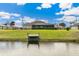 Peaceful waterfront view with private dock and green space at 497 Rotonda Cir, Rotonda West, FL 33947