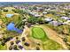 Beautiful aerial view of a neighborhood with winding roads, water features, and a scenic golf course in the background at 52 Marker Rd, Rotonda West, FL 33947