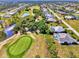 A captivating aerial view showcases the home's proximity to a scenic golf course and serene water features at 52 Marker Rd, Rotonda West, FL 33947