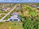 This aerial view showcases a serene home with a pool, solar panels, near a golf course and picturesque canals at 52 Marker Rd, Rotonda West, FL 33947