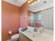 Well-lit bathroom showcasing a vanity with a large mirror and a separate tiled shower area at 52 Marker Rd, Rotonda West, FL 33947