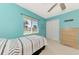 Bright bedroom features a ceiling fan, closet, dresser, and a large window for natural light at 52 Marker Rd, Rotonda West, FL 33947