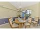 Elegant dining room with stylish table and chairs under a decorative chandelier at 52 Marker Rd, Rotonda West, FL 33947