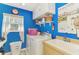 Efficient laundry room with washer, dryer, storage cabinets, a utility sink, and bright blue walls at 52 Marker Rd, Rotonda West, FL 33947