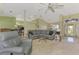 Well-lit living room with comfortable seating and view into the kitchen area at 52 Marker Rd, Rotonda West, FL 33947