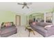 Bright living room featuring a ceiling fan, plush seating and neutral carpet flooring at 52 Marker Rd, Rotonda West, FL 33947