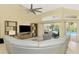 Open-plan living room with stylish sofa, media center, and view of the pool area at 52 Marker Rd, Rotonda West, FL 33947