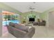 Bright living room with vaulted ceiling, comfortable furnishings overlooking pool area at 52 Marker Rd, Rotonda West, FL 33947