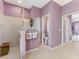 Primary bathroom with shower stall, toilet room and tiled floor, painted in a soft purple at 52 Marker Rd, Rotonda West, FL 33947