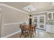 Dining area with wooden table and chairs, adjacent to kitchen and pool access at 5292 Early Ter, Port Charlotte, FL 33981