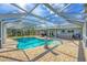 Inviting kidney-shaped pool with screened enclosure and hot tub at 5292 Early Ter, Port Charlotte, FL 33981