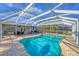 Relaxing kidney-shaped pool with screened enclosure and hot tub at 5292 Early Ter, Port Charlotte, FL 33981