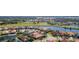 Wide aerial view of a neighborhood with golf course and lake at 5560 Club View Ln, North Port, FL 34287