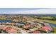 Wide aerial view of neighborhood with golf course and lake at 5560 Club View Ln, North Port, FL 34287