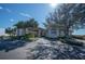 Elegant community clubhouse entrance with palm trees at 5560 Club View Ln, North Port, FL 34287