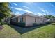 Tan house with red tile roof, landscaping, and a screened patio at 5560 Club View Ln, North Port, FL 34287