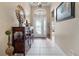 Bright foyer featuring a wooden console table and decorative accents at 5560 Club View Ln, North Port, FL 34287