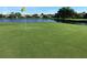 Golf course putting green with lake and houses in background at 5560 Club View Ln, North Port, FL 34287