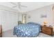 Bright bedroom with double bed, nightstand, and closet at 615 Apple Ln, Englewood, FL 34223