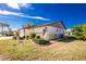 House exterior showcasing landscaping and garage at 615 Apple Ln, Englewood, FL 34223