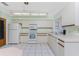 Bright kitchen with white cabinets, microwave and stove at 615 Apple Ln, Englewood, FL 34223